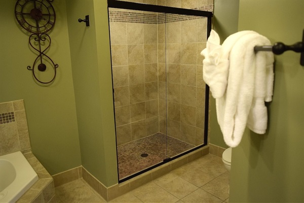 Walk-in tile shower in the primary bathroom