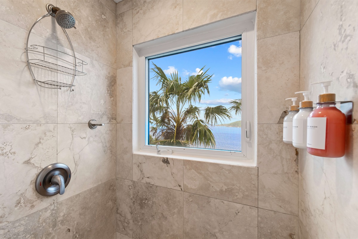 Modern bathroom with double vanity, hair dryer, walk-in shower, and spa-like vibes to refresh after a beach day.