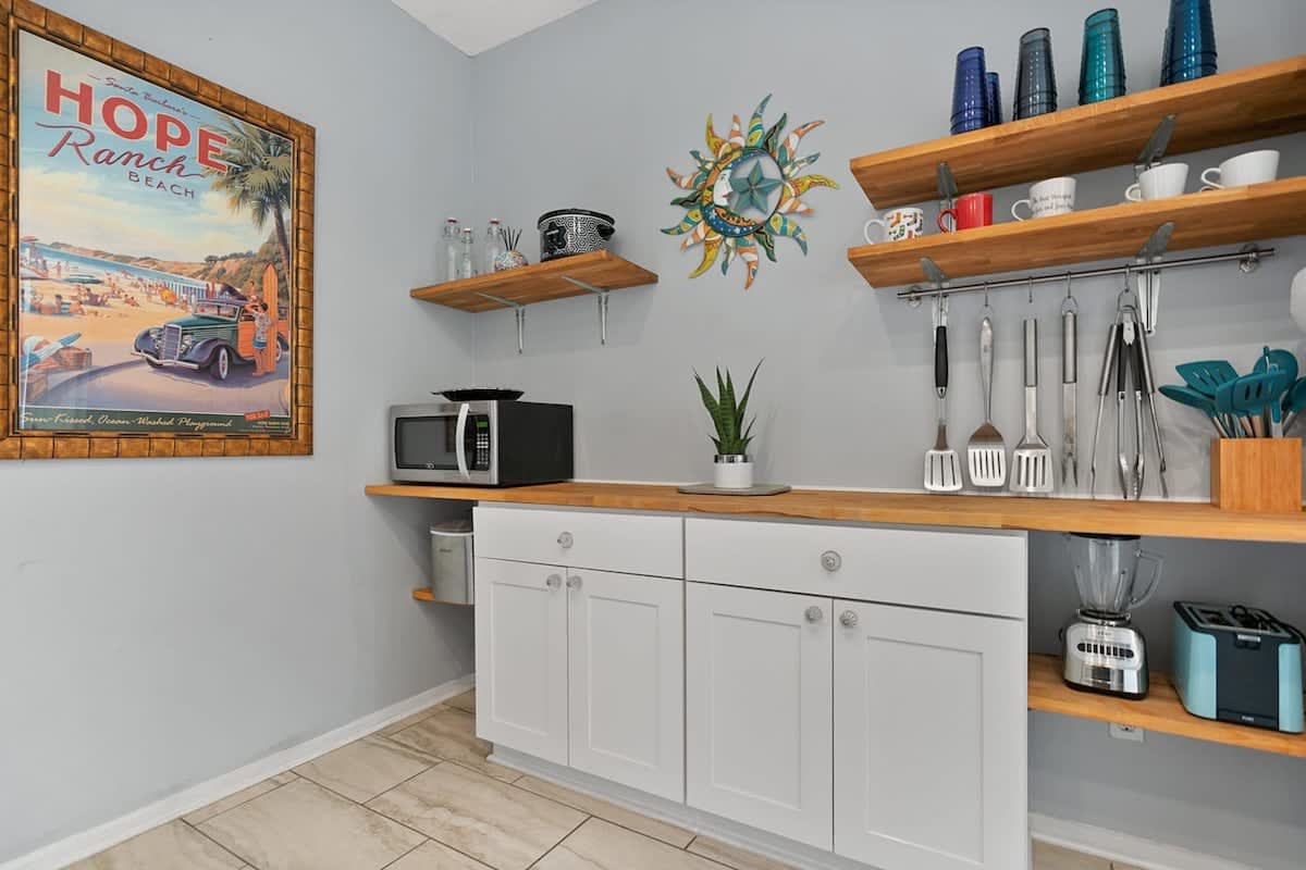 The coffee and pantry counter, with the microwave, toaster and open shelving. There is a drip coffee maker and a Keurig, so the early risers and the late risers can each be served without any negotiation.