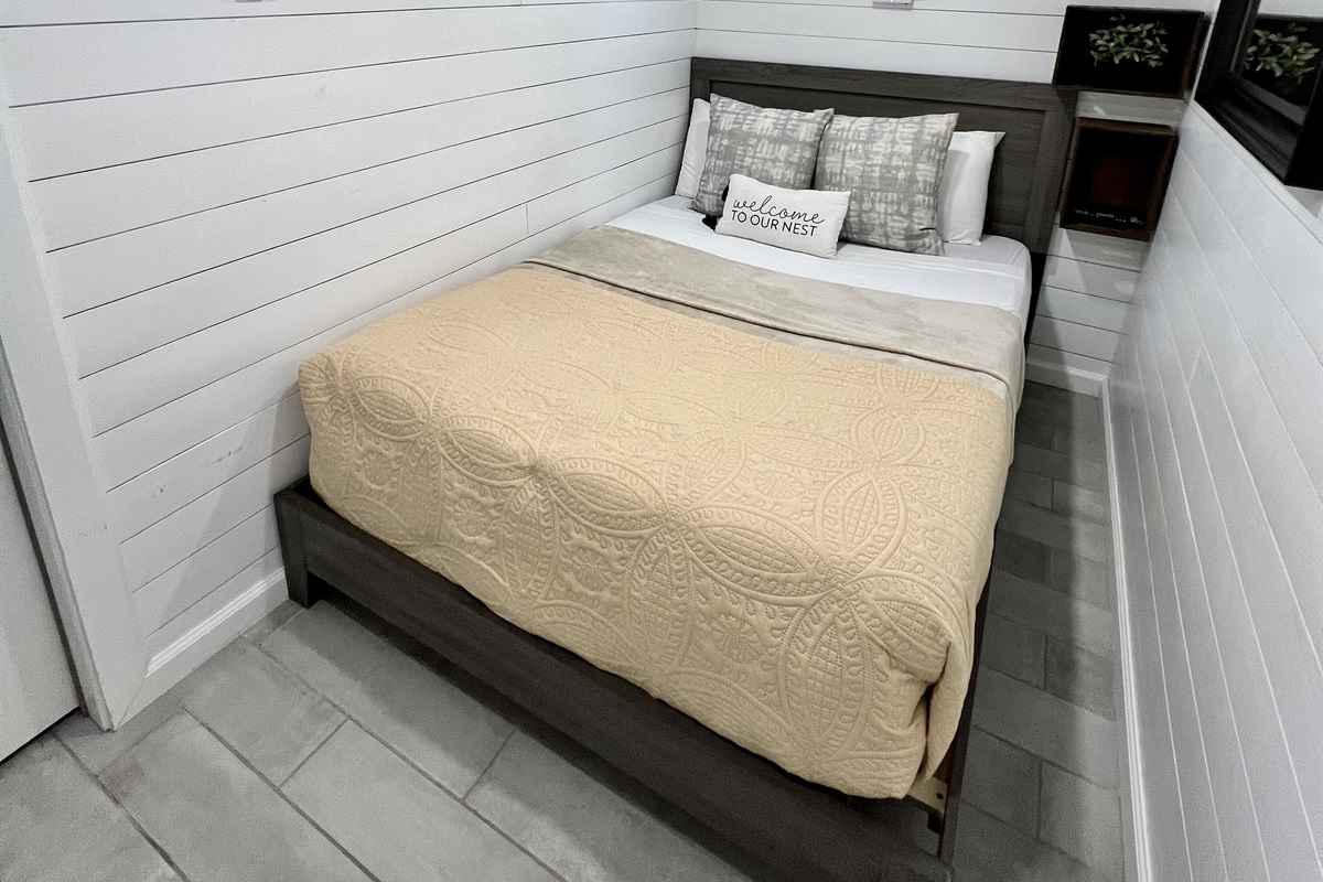 Downstairs bedroom with full size bed and smart tv