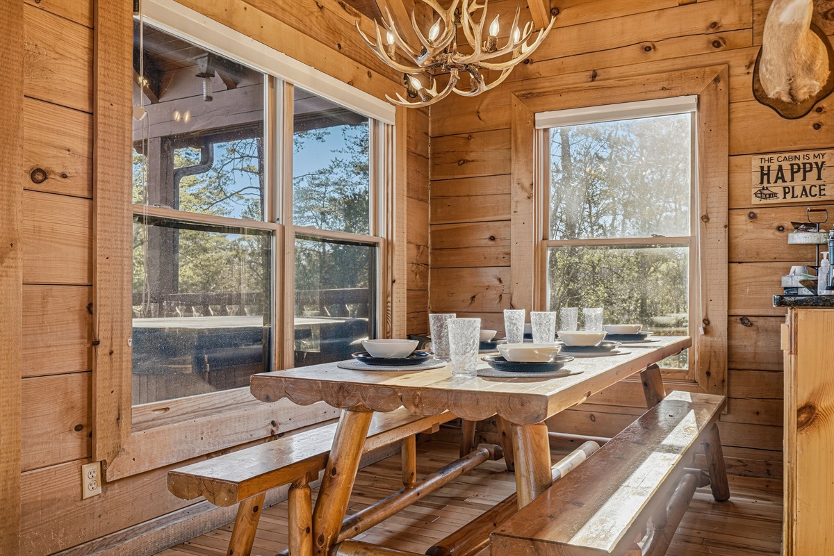 "The Cabin Is My Happy Place" &mdash; and this sun-drenched dining room proves it | Handcrafted log picnic table, antler chandelier & walls of windows make every meal feel like a Smoky Mountains moment