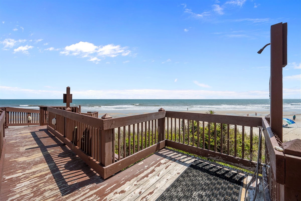 Relax on the oceanfront deck just steps from the beach