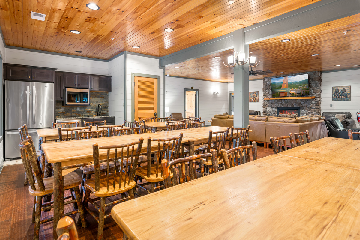 Solid wood tables that seat all 60+ guests at once. Set for a family-style meal, a group dinner, or a morning devotional. No restaurant reservations, no splitting up — everyone eats together.