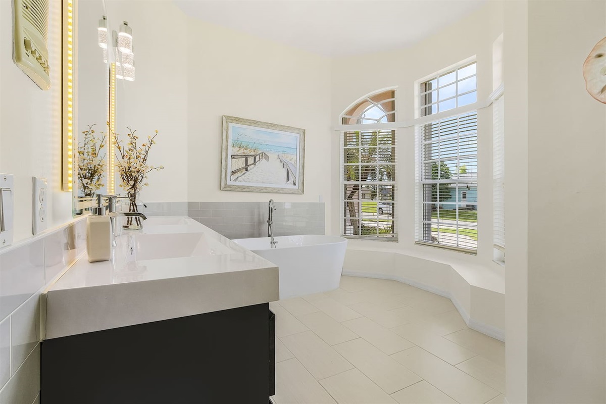 Indulge in the spa-like luxury of the ensuite bathroom with dual sinks, a relaxing tub, and a rejuvenating shower!