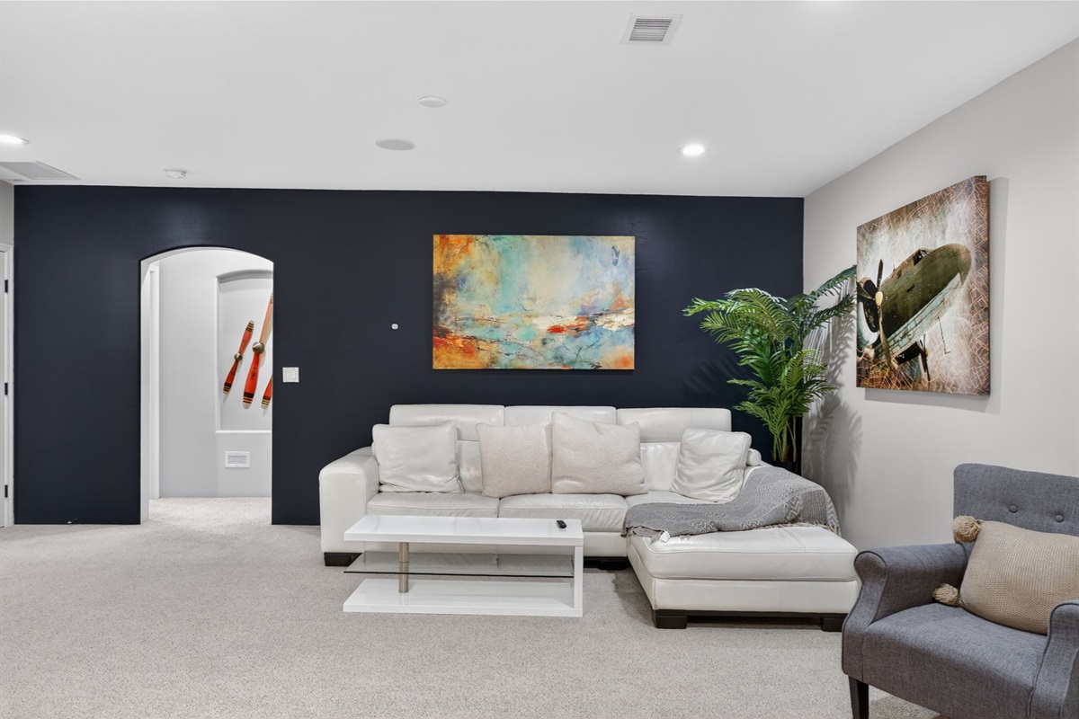 Large basement living room with sectional seating perfect for movie nights and group gatherings
