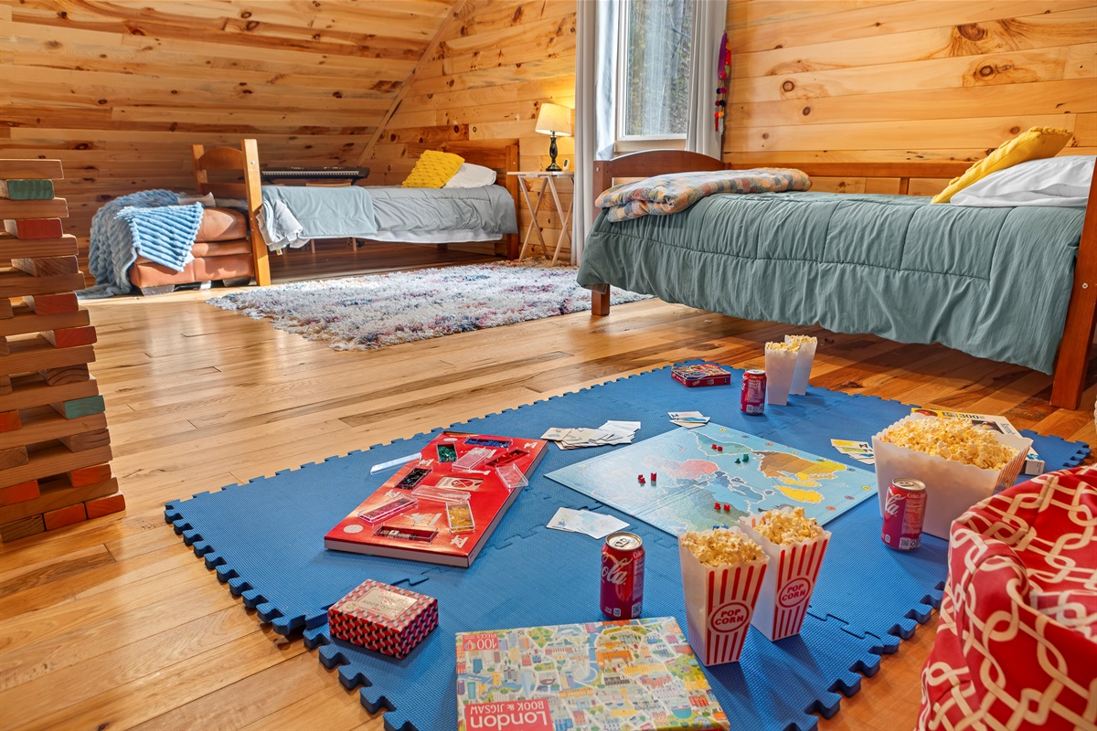 Loft Bedroom 4: Game nights await in this vibrant playroom with fun decor and comfy beds!