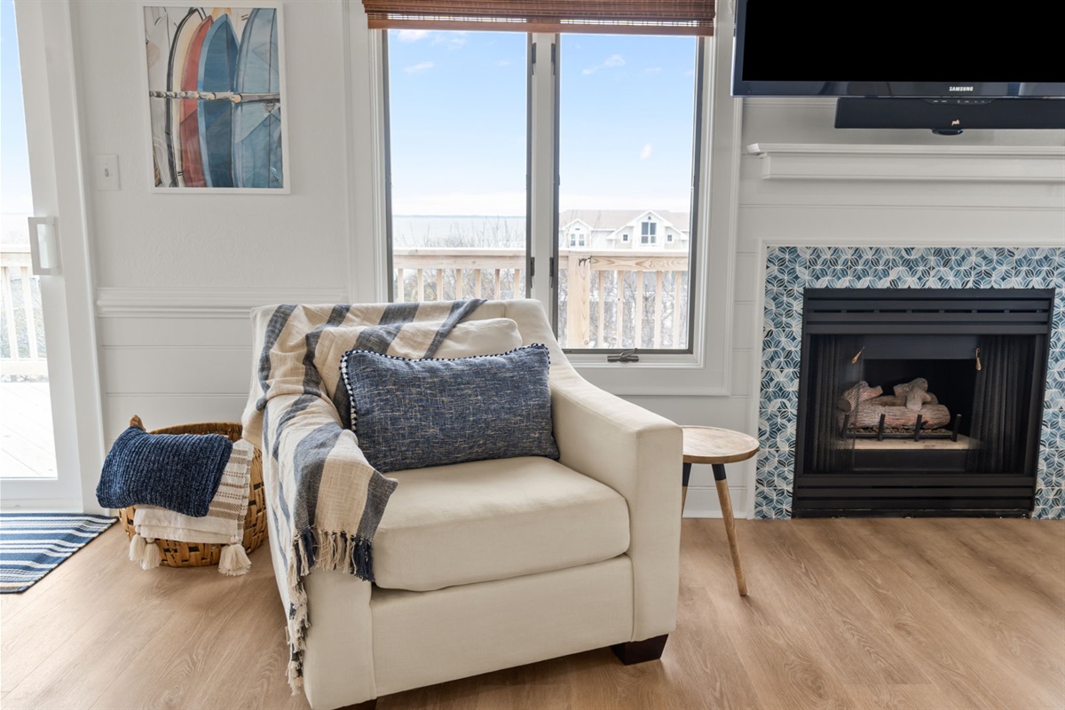Living room corner with fireplace and seating, perfect for cozy evenings.