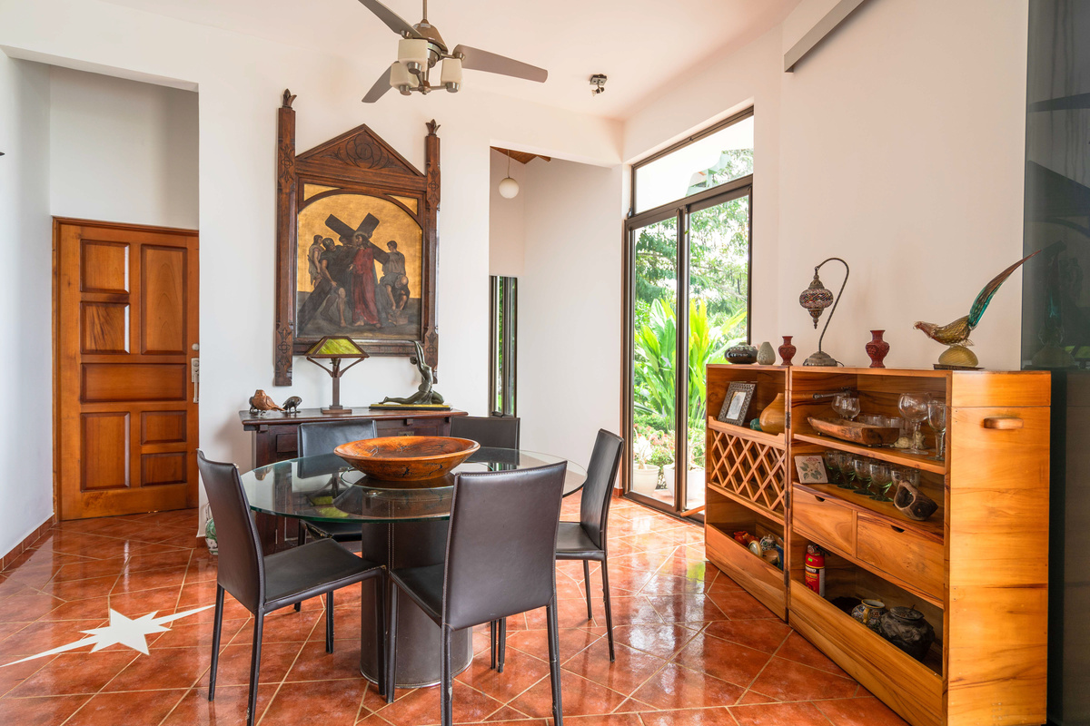 Dining area with handcrafted furnishings and lush garden views