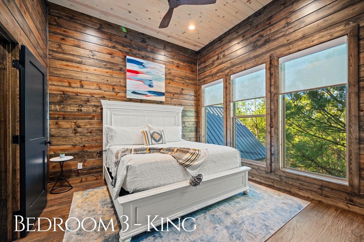 This king bedroom feels peaceful and private, with warm wood tones and natural light that keeps it feeling calm and comfortable.