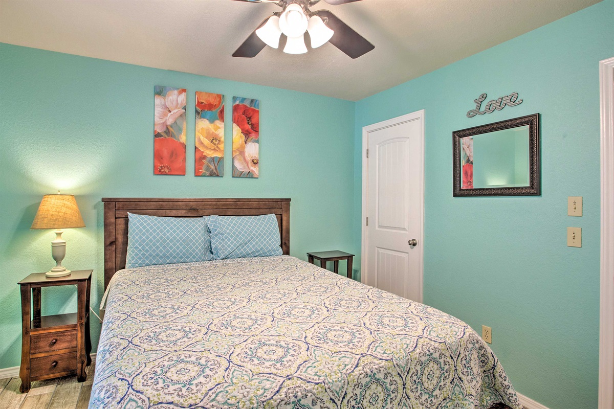 Master bedroom with queen size bed, walk in closet, and attached bathroom.