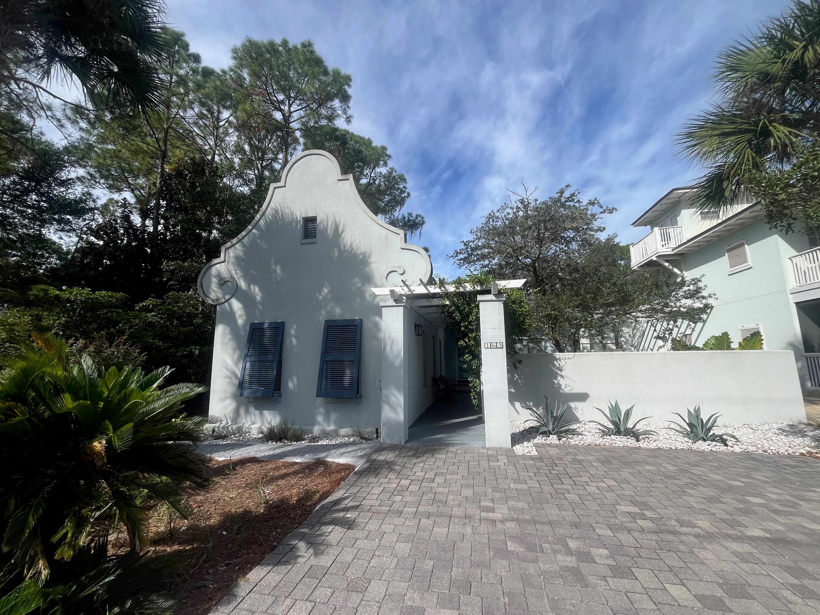 Mediterranean 1 level living steps from the beach with lush tropical courtyard and private pool.