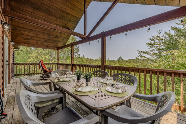 Dine outdoors on the covered deck while enjoying peaceful Smoky Mountain views.