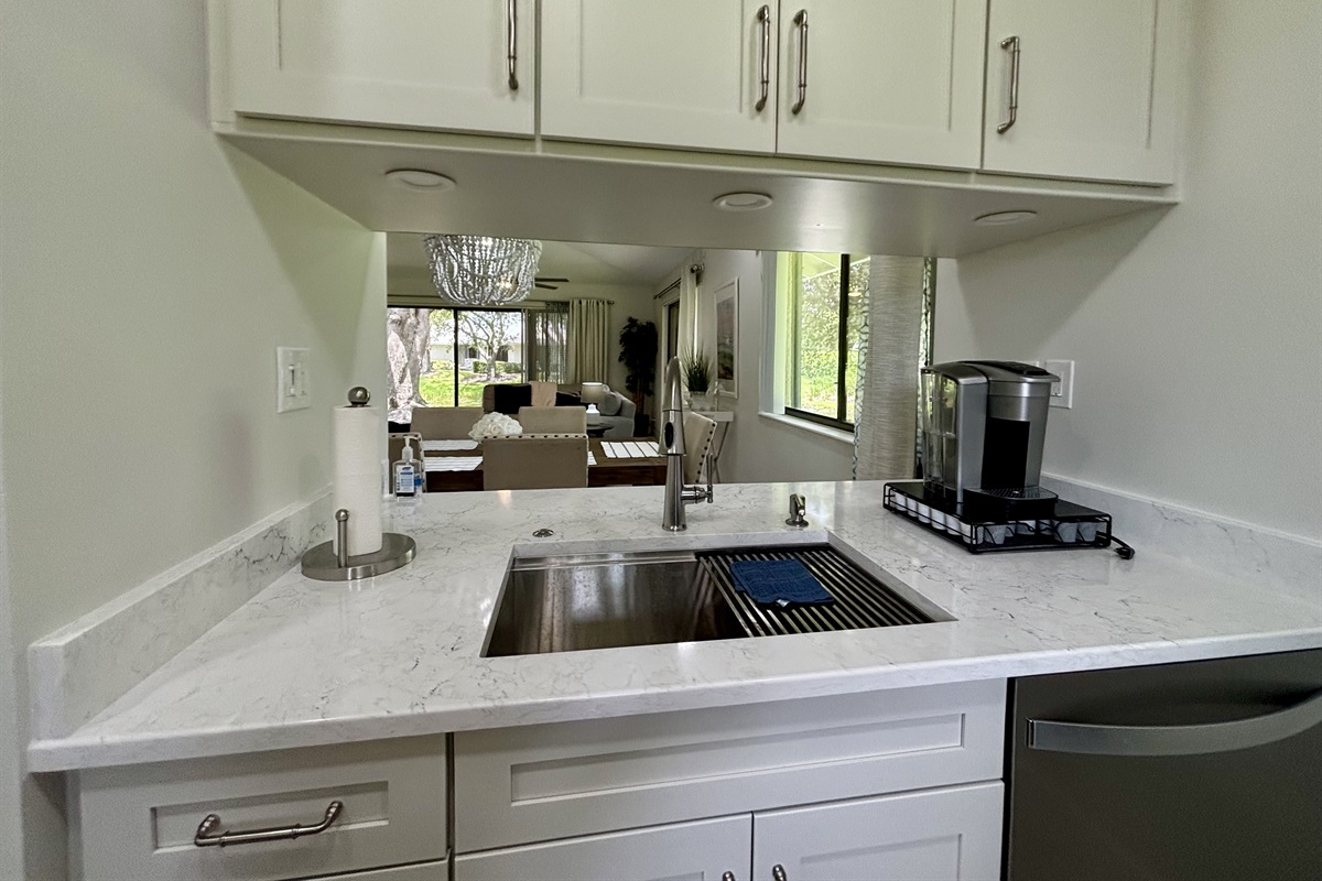 The galley-style kitchen is well-equipped with all the essentials needed to make home-cooked meals together.
