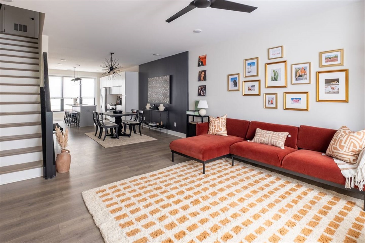 The plush velvet sofa is framed by a hand-selected collection of art. Sit in the spacious living room and catch up with friends - or a movie!