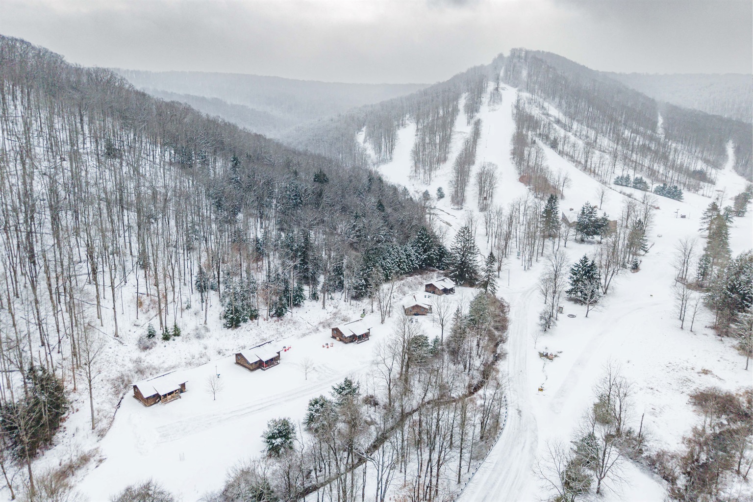 Snow-covered Denton Go Cabins tucked into the mountains of Denton Hill—peaceful, private, and surrounded by Pennsylvania wilderness.