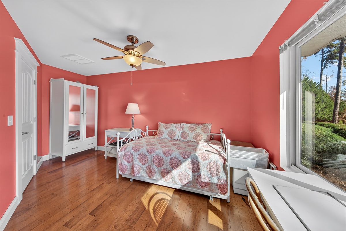 Wake up to beautiful lake views from this sunny guest room.