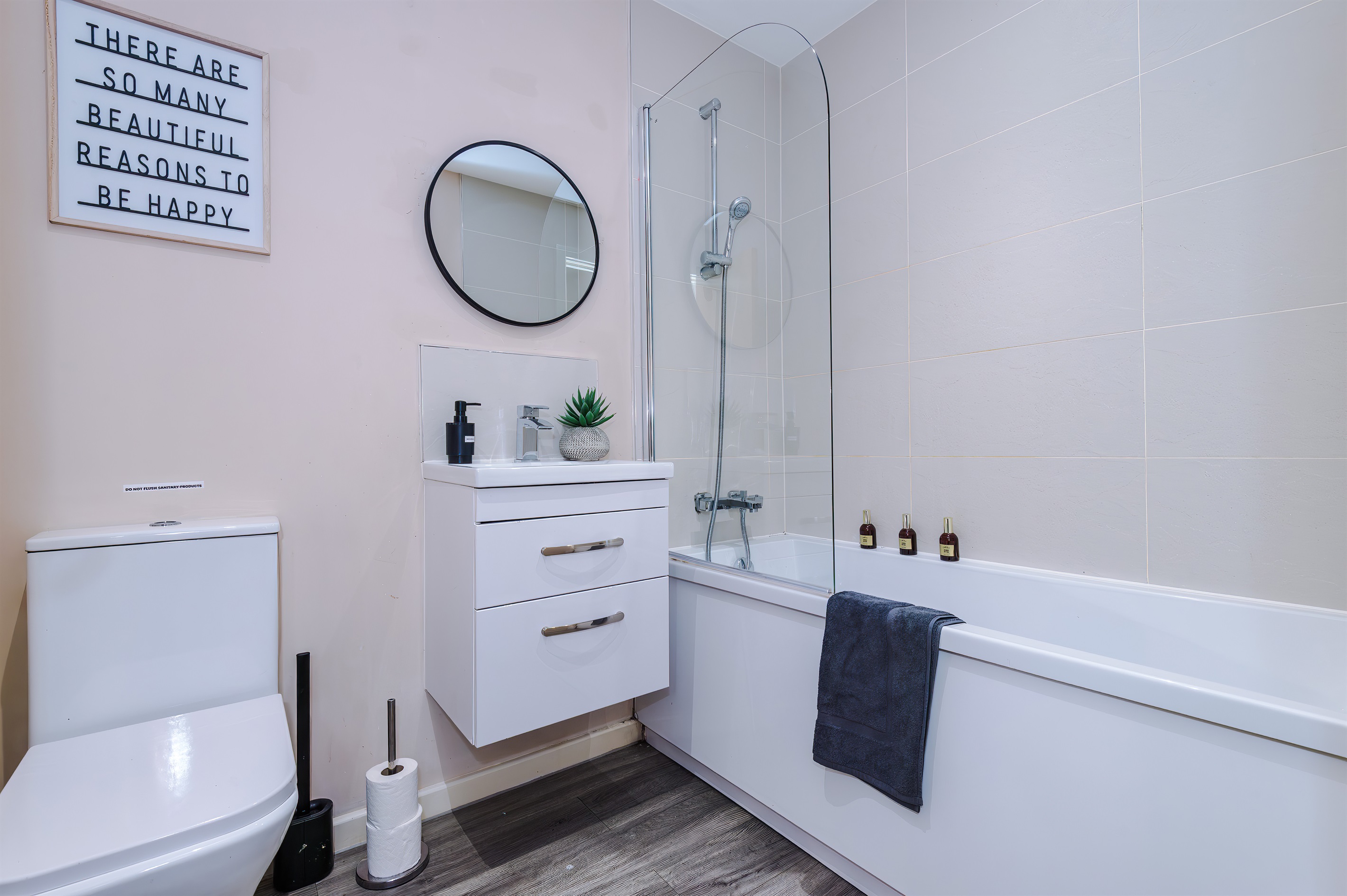 The modern bathroom benefits from a toilet, basin, shower & bath with shampoo & body wash on arrival