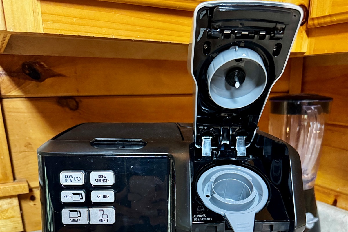 Coffee maker accepts grounds or pods