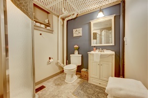 Toilet next vanity and mirror