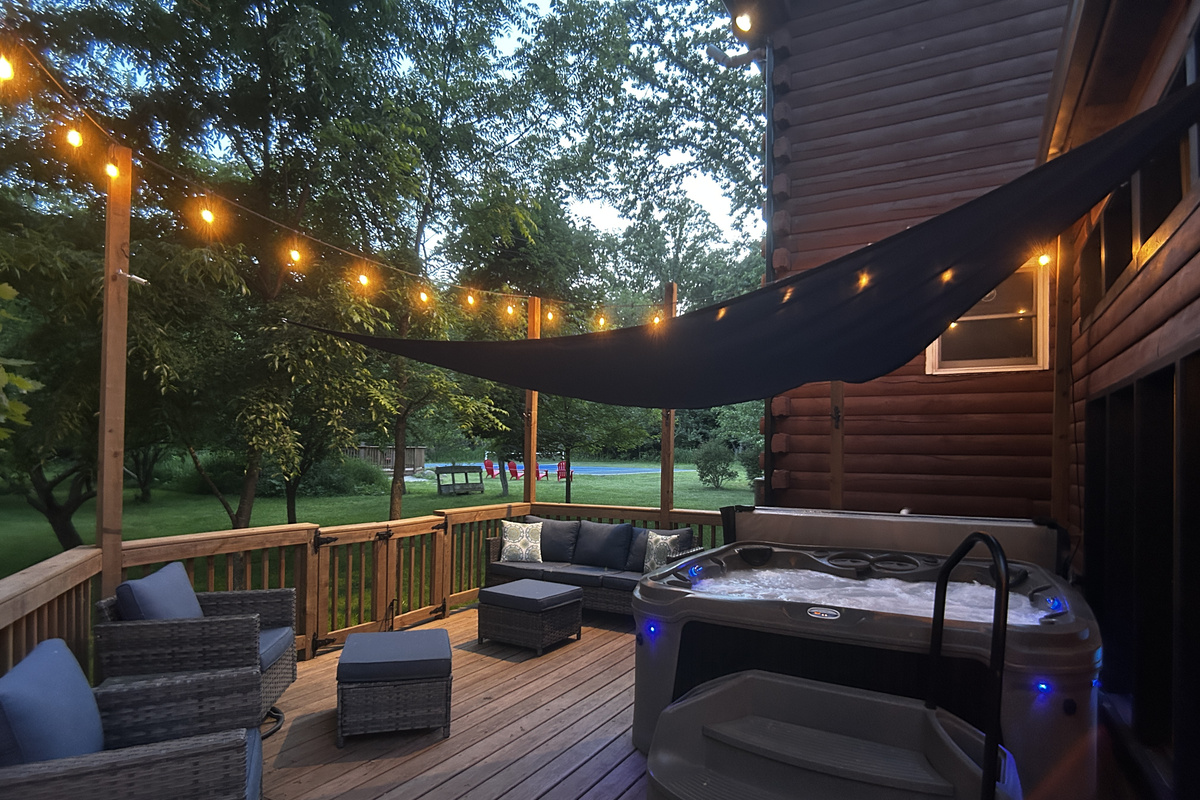 Seating for 7 by the hot tub. The shade sail is installed over the hot tub in warmer months.