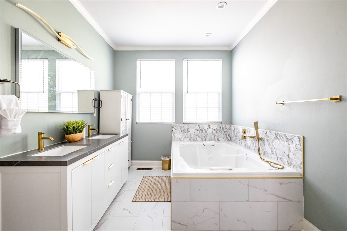 Luxury en-suite bathroom with 2-person air massaging bath, tiled rain shower, and double vanity