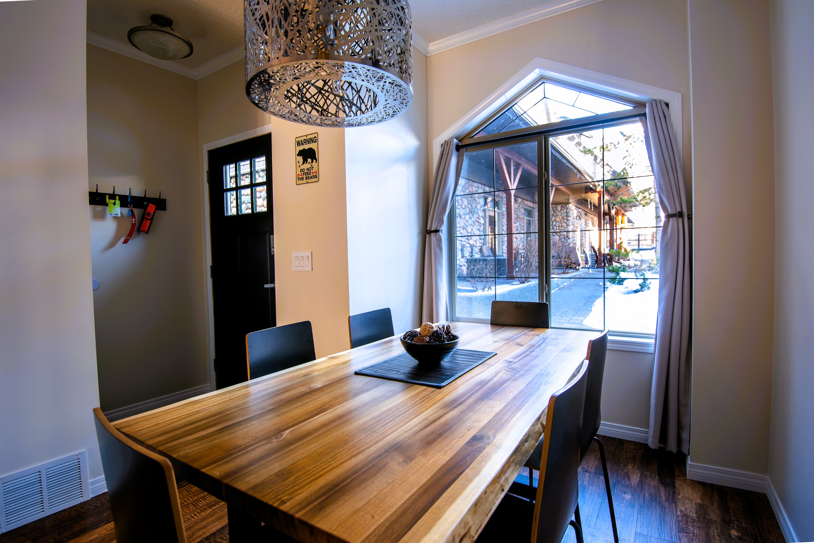 Dining area, seating for 6, adjacent to kitchen, entryway and inner courtyard visible in the background.