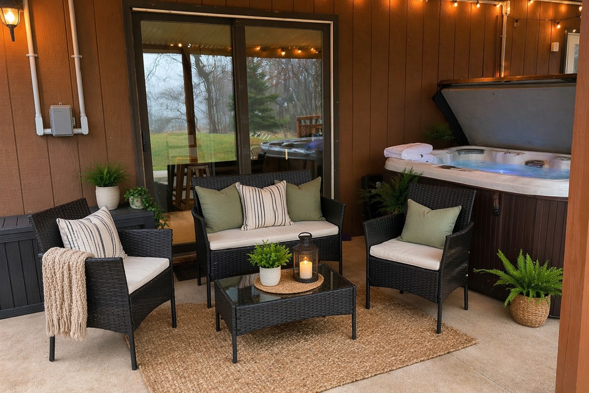 Relax in comfortable seating on the covered patio under the deck while others enjoy the hot tub just steps away