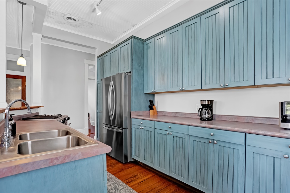 Bold blue cabinets and stainless appliances bring modern flair to this classic space.