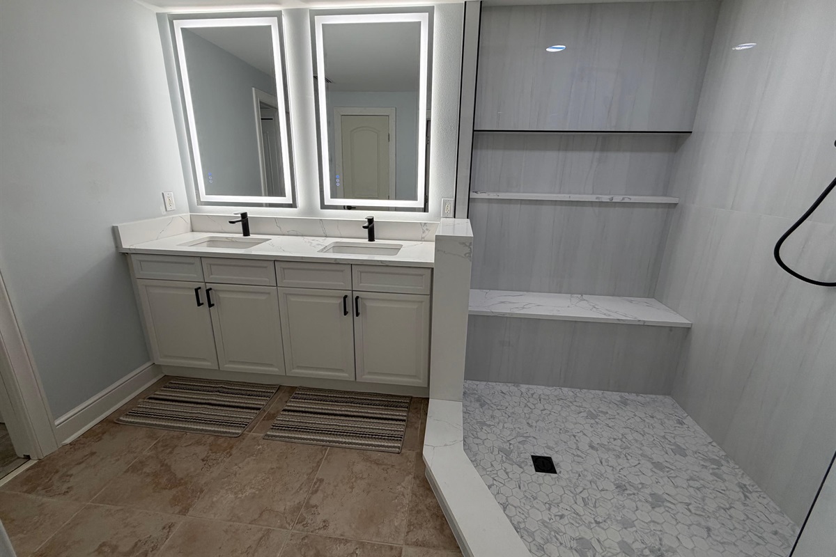 Start your day with plenty of space—double sinks, bright lighting, and a large walk-in tiled shower make mornings easy for everyone.