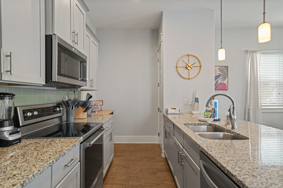 Bright, open kitchen with granite countertops and modern finishes.