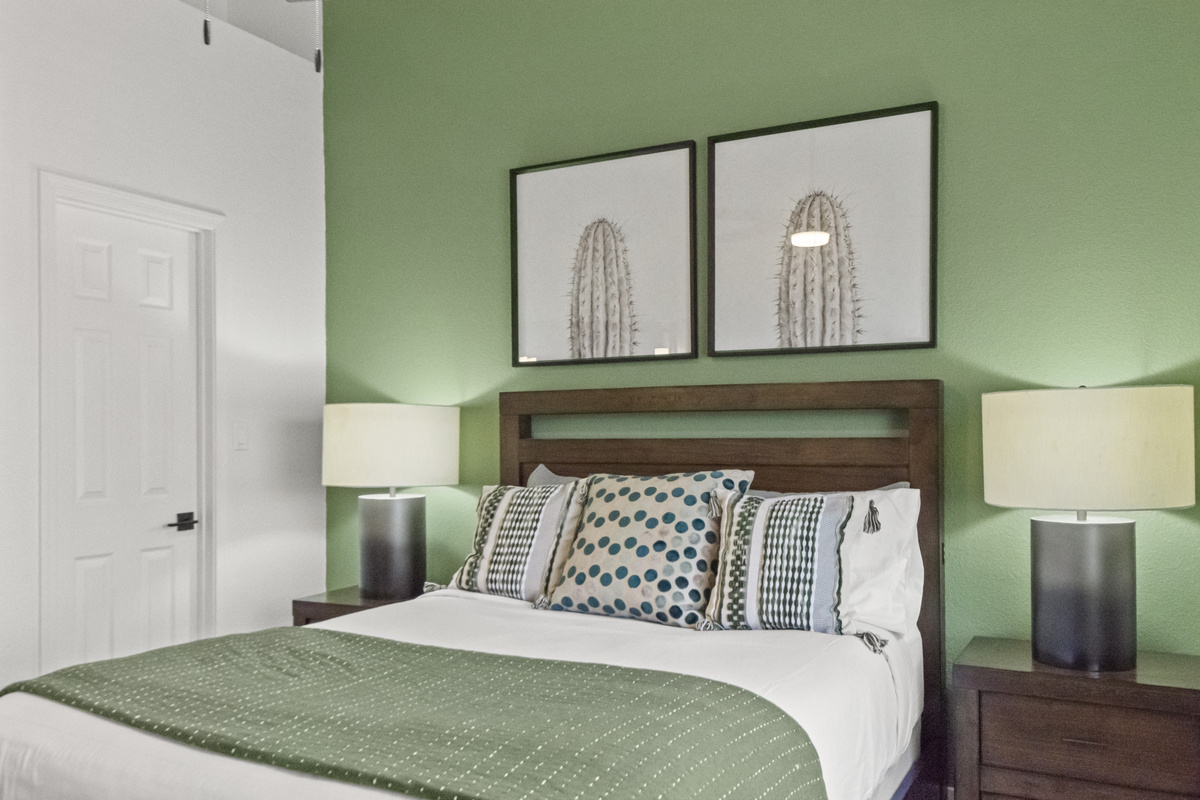 Spacious bedroom designed for a restful stay, featuring a comfortable bed, nightstands, and bright natural light.

