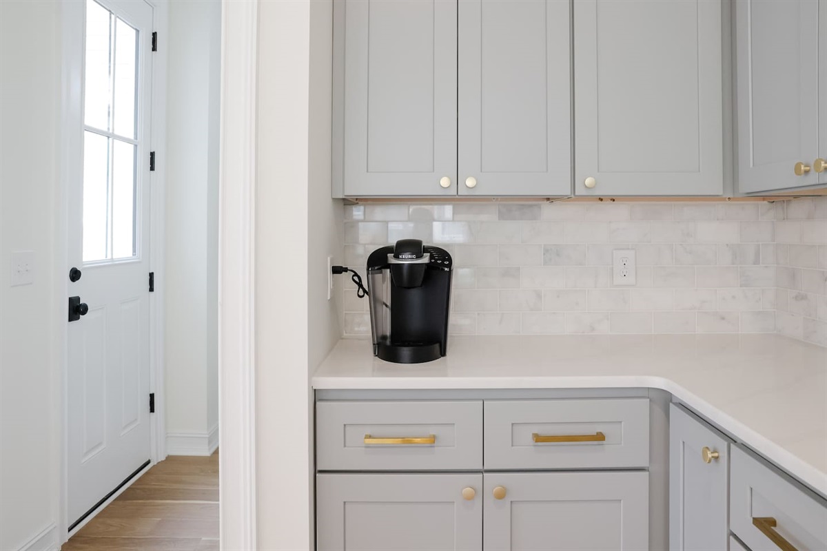 Lots of counter and cabinet space make for easy entertaining. The kitchen comes complete with stovetop, oven, microwave, fridge, freezer, and Keurig coffee maker. 