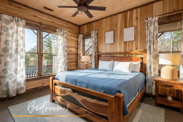 Second master bedroom located downstairs, offering comfort and relaxation with a mountain view.