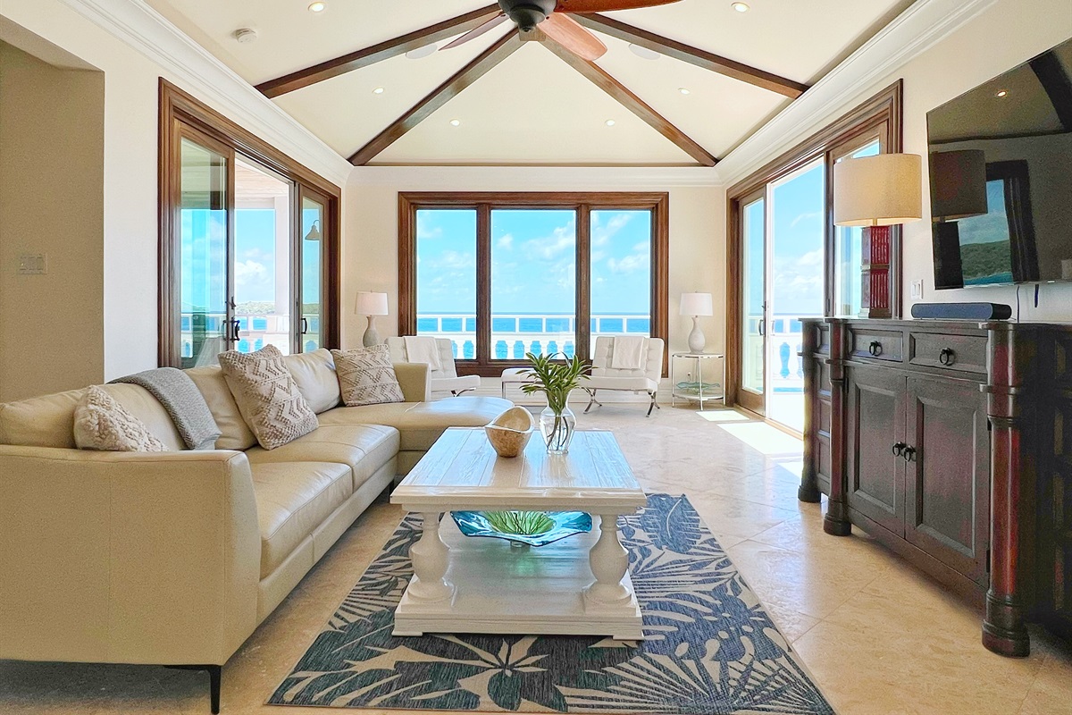 Relax in the bright living room with ocean views and tropical charm.
