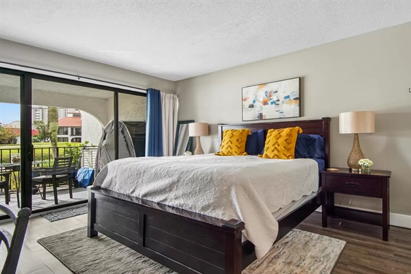 King in the main bedroom with patio access