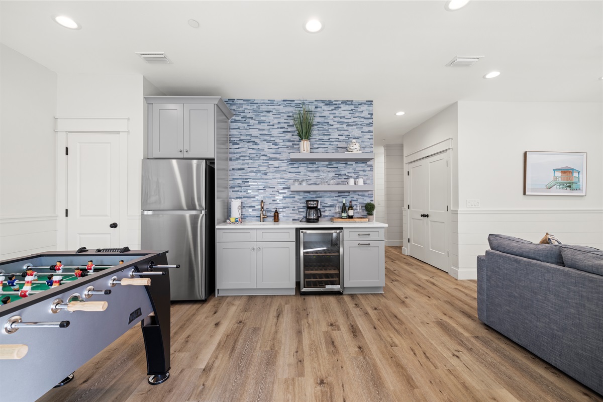 2nd floor game room is just off the 2nd floor living room equip with a wine cooler, sink, foosball and full size refrigerator