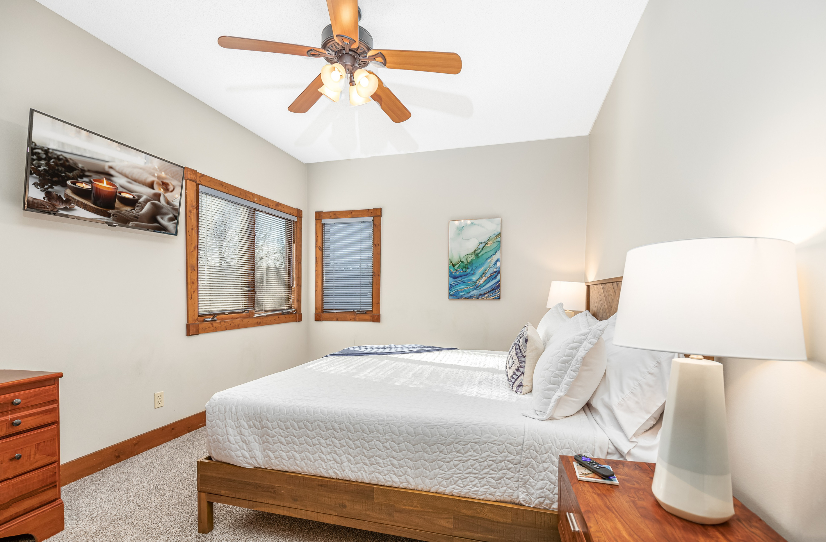 Bedroom 2 featuring a King bed and a Roku Smart TV, and a bathroom directly adjacent to the bedroom; one of two bedrooms located on the main floor.