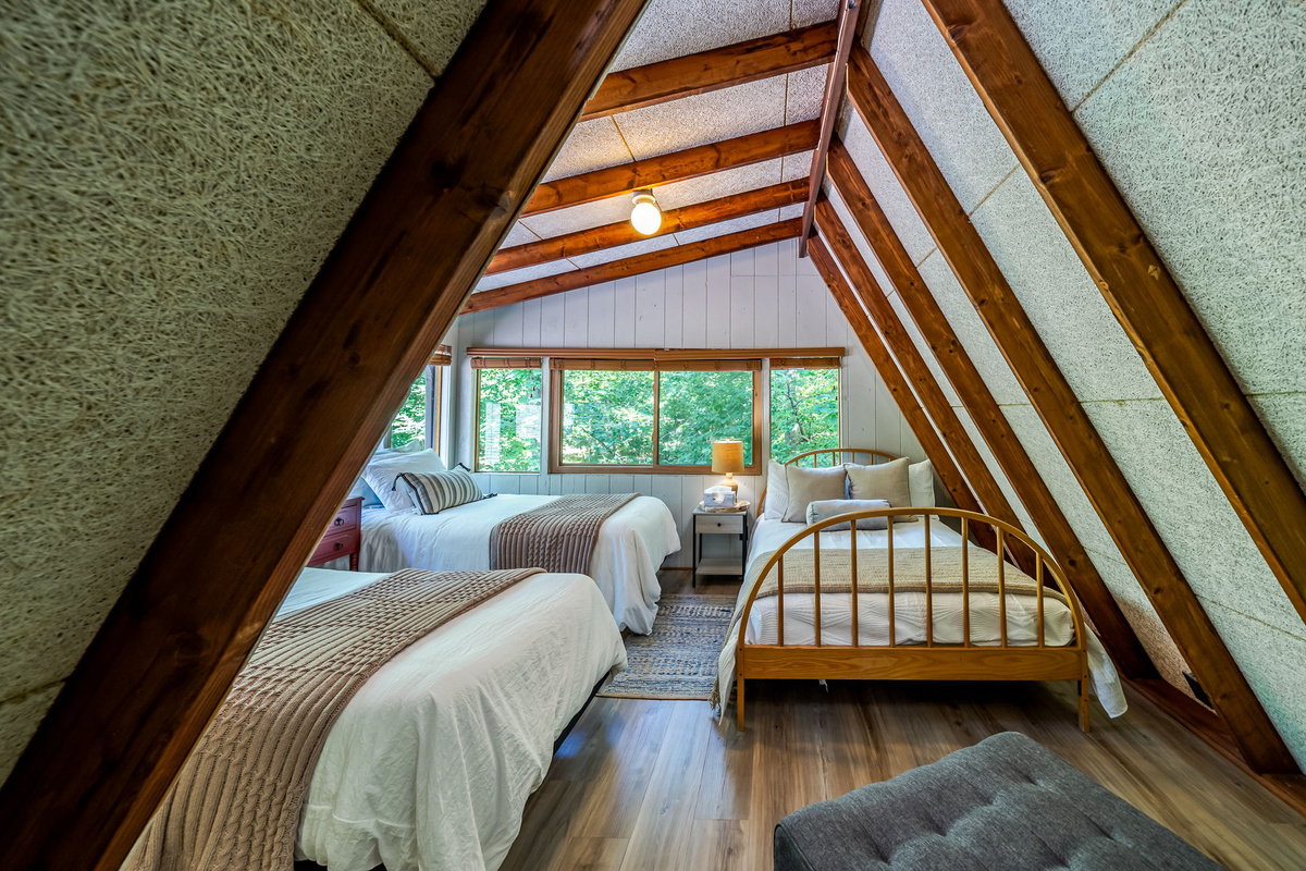 Claim the loft for the kids — two twin beds and 1 full bed tucked under the 2nd floor A-frame roofline, and they'll be claiming their bed before you unload the car.