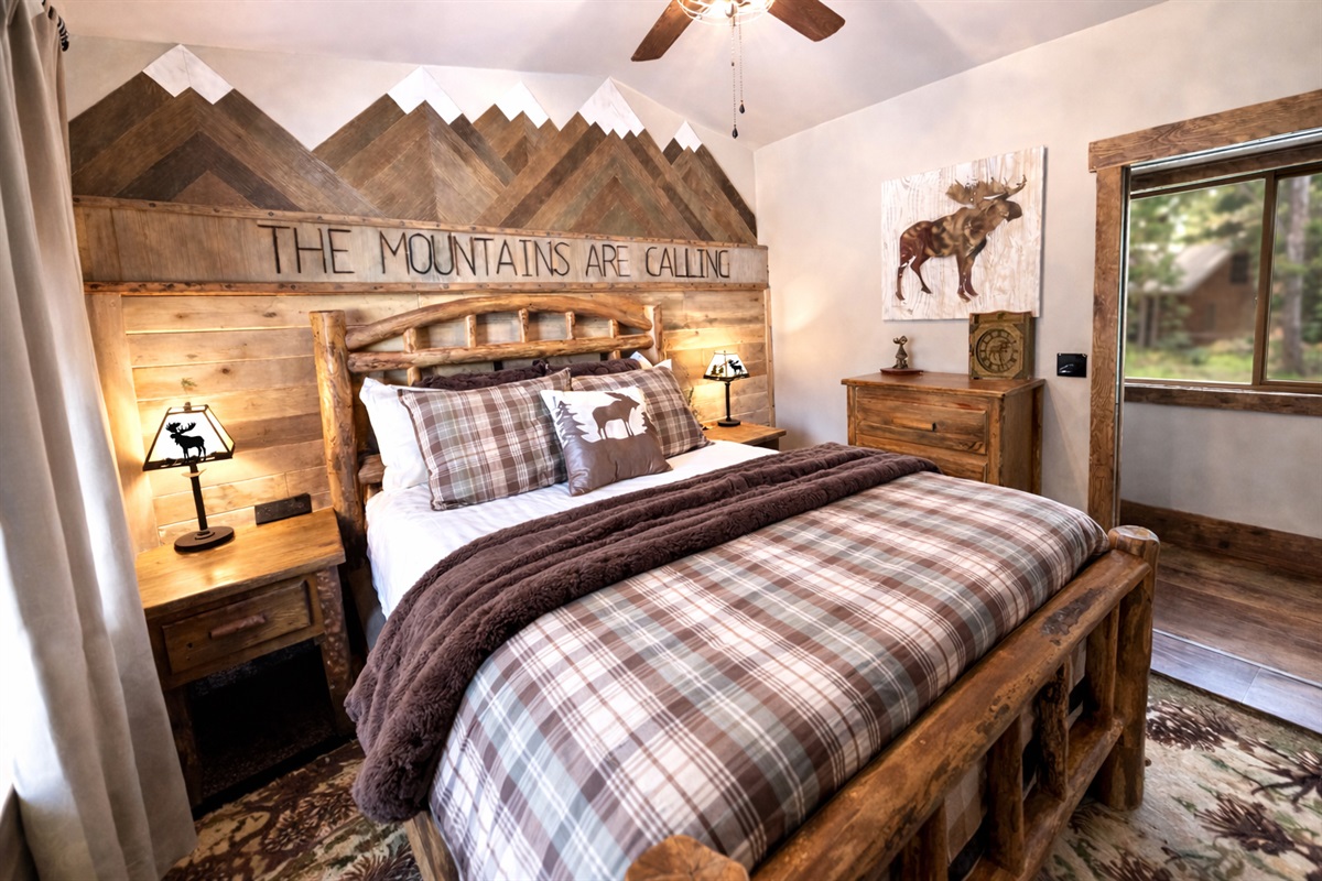 Main floor bedroom | Queen bed. Equipped with a Smart TV, premium pillows/linens, room-darkening curtains, ceiling/window fans, charging stations, bedside lamps, extra blankets and pillows.