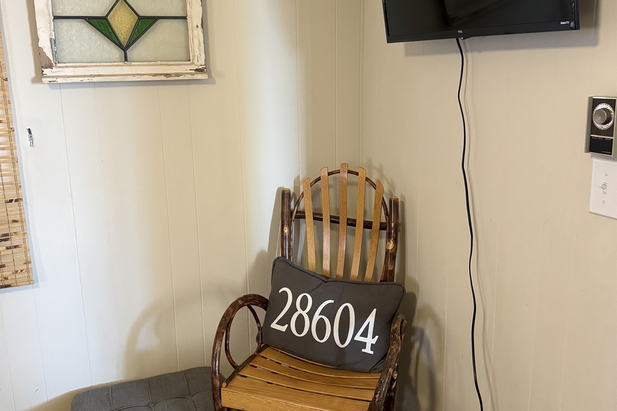 Our NEW Main floor King bedroom features a King bed, two nightstands, charging outlets with USB ports, luggage racks, a closet to hang clothes, a chair to sit & rest, a Roku Smart TV. You'll be the closest to the coffee maker in the morning! ;)