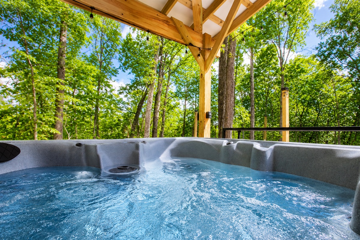 Private hot tub surrounded by trees — the perfect place to relax and unwind after a quiet day in nature