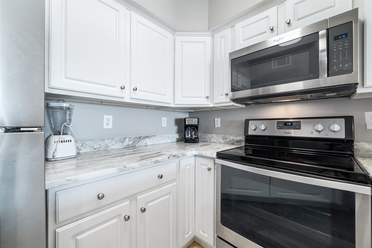 Modern kitchen essentials at your fingertips. This countertop setup offers everything you need for a quick breakfast or a relaxing cup of coffee.