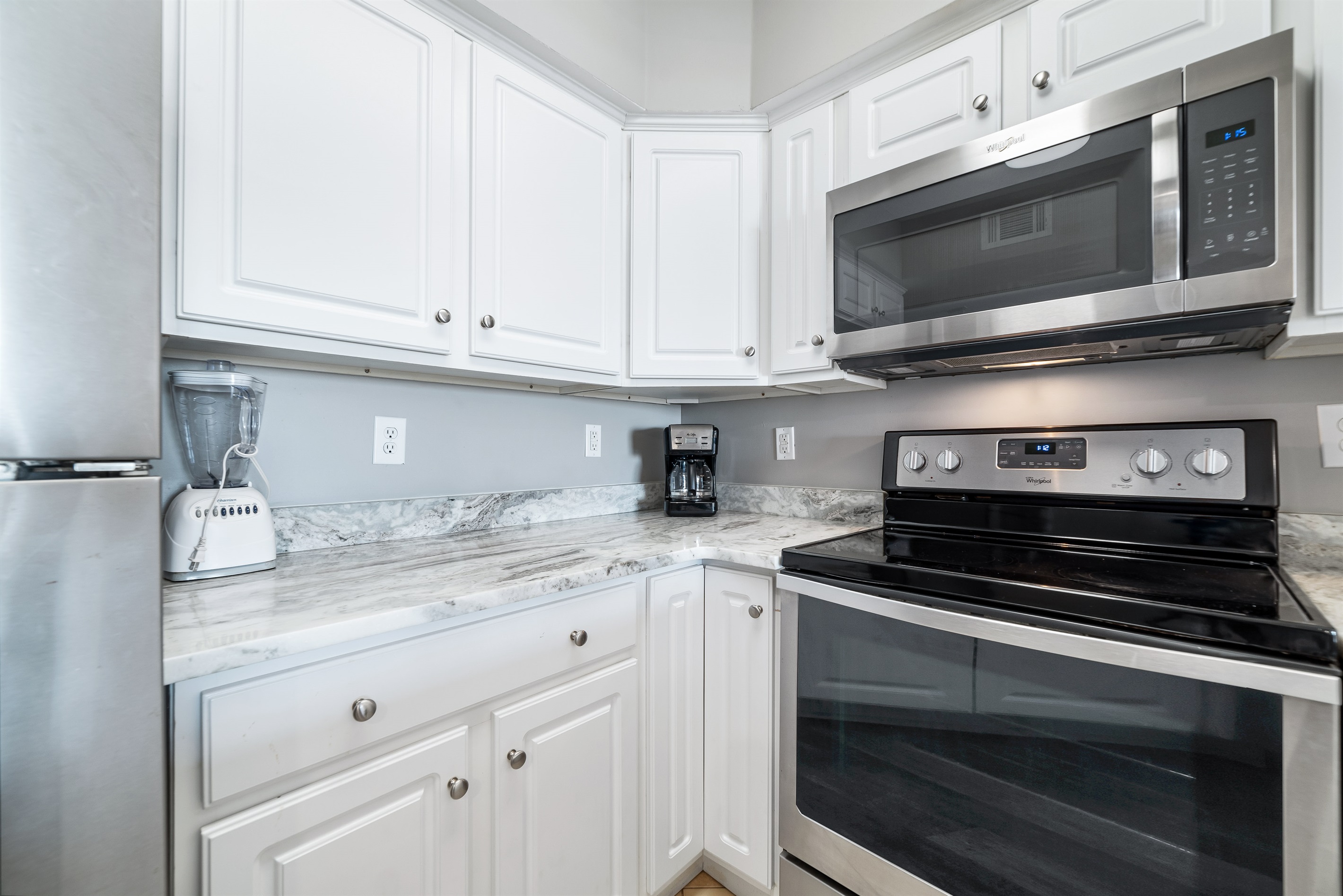 Modern kitchen essentials at your fingertips. This countertop setup offers everything you need for a quick breakfast or a relaxing cup of coffee.