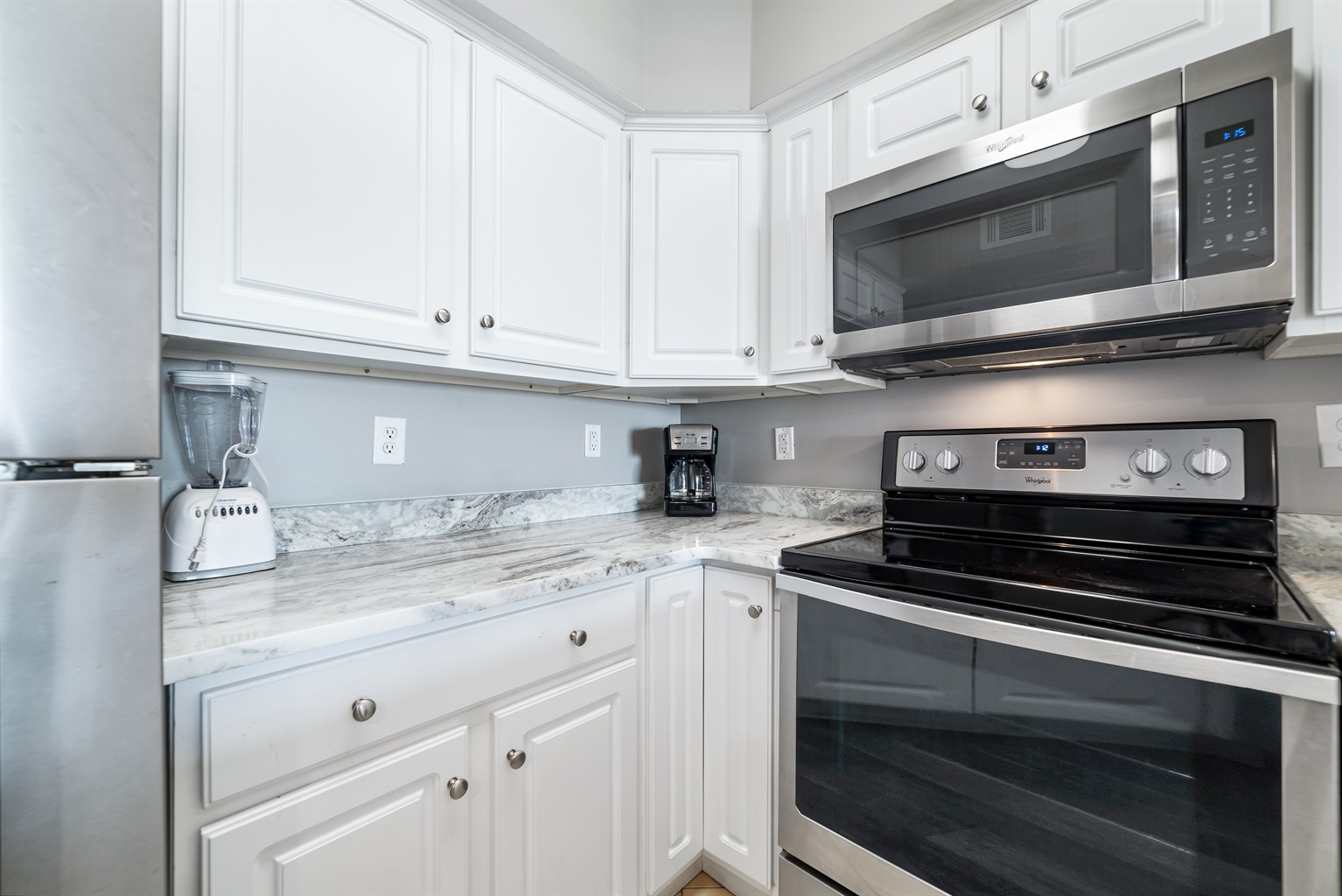 Modern kitchen essentials at your fingertips. This countertop setup offers everything you need for a quick breakfast or a relaxing cup of coffee.