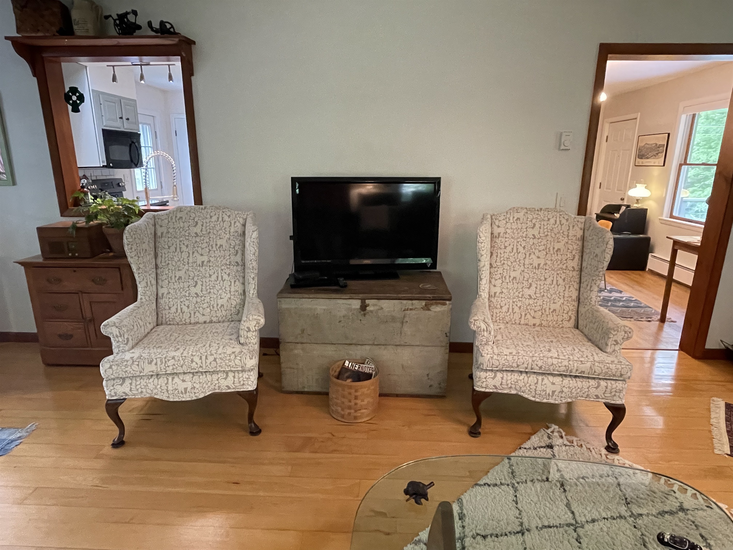 Living room TV flanked by wingback comfy chairs.