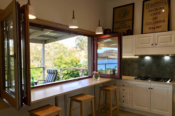 Kitchen's Breakfast bar with bifold windows towards verandah