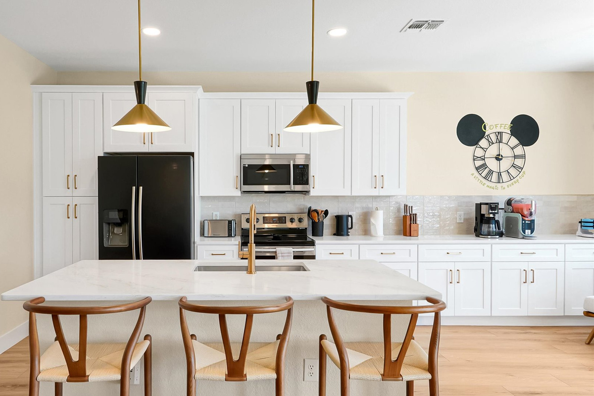 Kitchen: Fully renovated kitchen with generous storage, modern appliances and island seating for three.