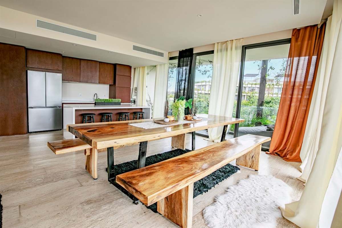 Dinning area flows from the kitchen and next to two balconies and private patio with pool