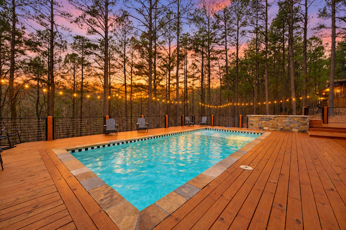 Watch the sunset glow across the pool as evening settles into the trees.