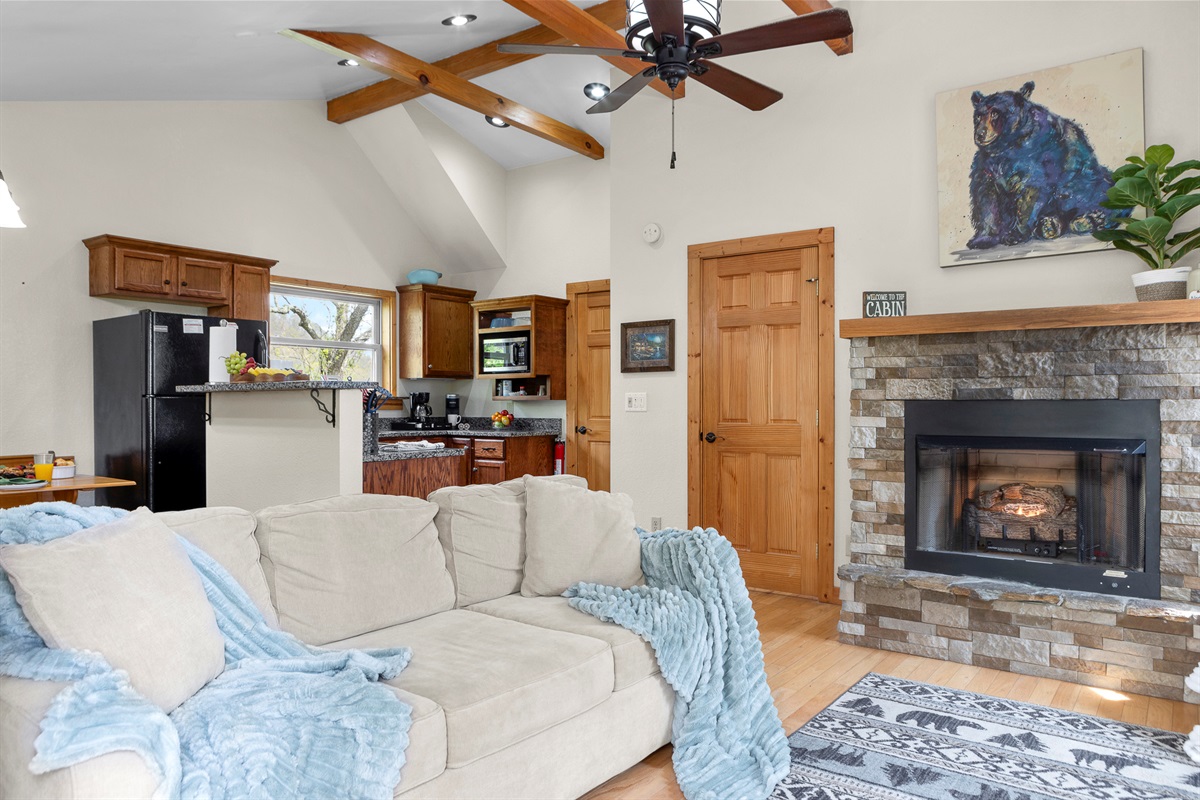Living Room Retreat: Spacious area with comfy seating, a cozy fireplace, and rustic charm await you!